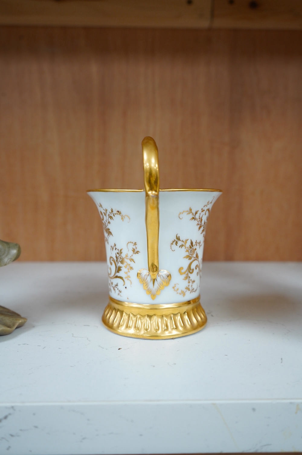 An armorial mug with lithophane figural scene to the base, together with a similar cup, largest 12cm high. Condition - mug poor, cup is good